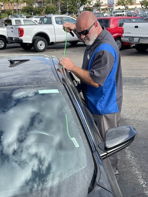 opening a car door with a long reach tool